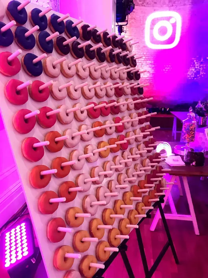 Donut wall hire Melbourne with colourful glazed doughnut wall at a brand party