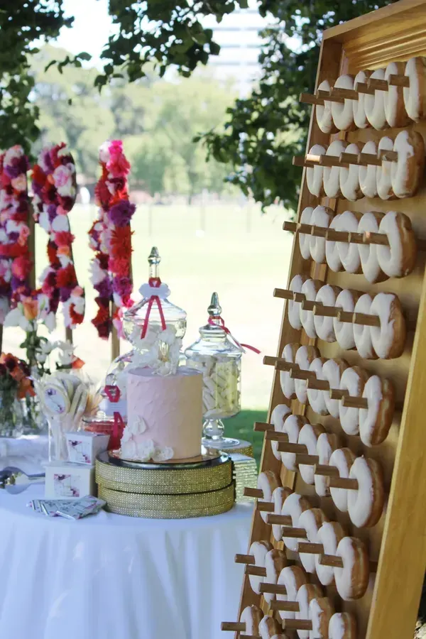 Donut board wedding styled outdoors with glazed donuts and dessert table